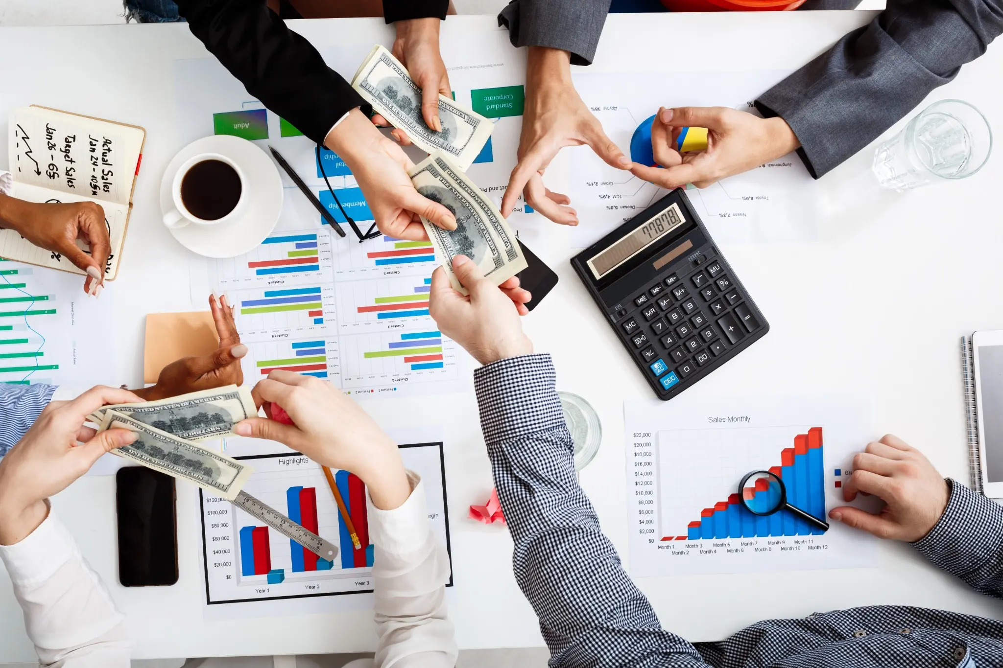 Financial team reviewing equity-market data, charts and investment calculations